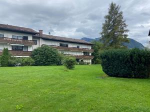 a large building with a green lawn in front of it at Bayern Lodge Grassau in Grassau