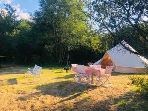 a table and chairs in front of a tent at Rose glamping, self catering, bell tent in St Austell