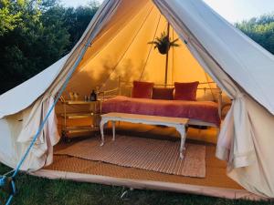 a large tent with a bed in it at Rose glamping, self catering, bell tent in St Austell +10 photos