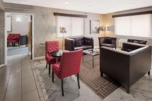 a hotel lobby with chairs and a table and a couch at Best Western Riverside Inn in Danville