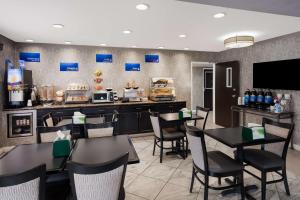 a restaurant with tables and chairs and a counter at Best Western Riverside Inn in Danville