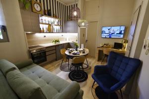 a living room with a couch and a table and a kitchen at Filoxenia Luxury Apartment in Nafplio +30 photos
