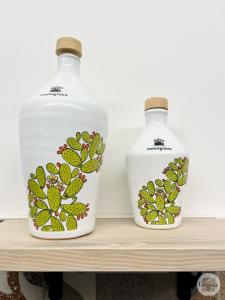 two bottles of water sitting on a shelf at Calamedde Guest House nel Centro Storico Pugliese in Fasano