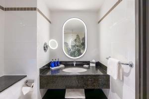a bathroom with a sink and a mirror at Radisson Blu Hotel, Glasgow in Glasgow