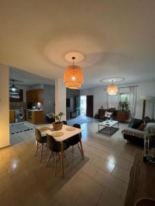 a living room with a dining table and a kitchen at Green Door Apartment in Limassol