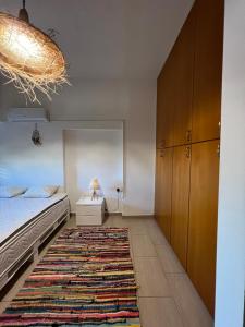 a bedroom with a bed and a rug at Green Door Apartment in Limassol