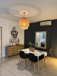a dining room with a table and a mirror at Green Door Apartment in Limassol +16 photos