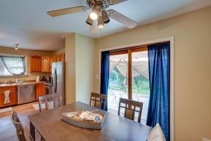 a kitchen and dining room with a table and a ceiling fan at Lakefront West Sand Lake Home with Beach Access! 