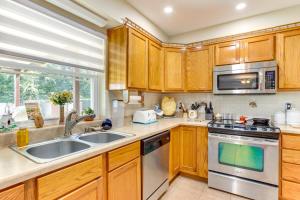 a kitchen with wooden cabinets and a sink at Cozy Oklahoma Retreat with Covered Patio and Gas Grill in Mustang