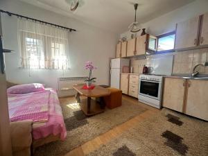 a kitchen with a bed and a table in a room at Eko Apartment Sarajevo in Sarajevo