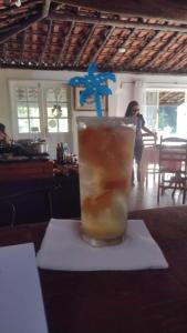a drink sitting on top of a table at Pousada do Tie - Rio Preto MG in Rio Prêto