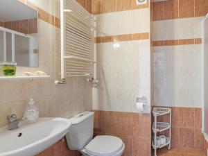 a bathroom with a toilet and a sink at Pensjonat KoGa in Kołobrzeg +23 photos