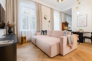 a living room with a couch and a table at Premium apartment in Parisian style in the heart of Old Krakow in Krakow