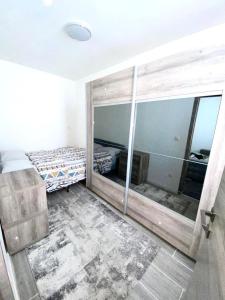 a bedroom with two beds and a large mirror at appartement douvres in Brussels