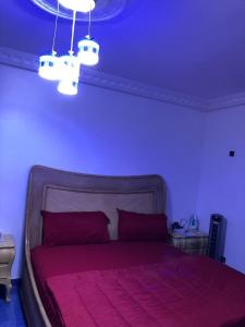 a bedroom with a bed with a purple ceiling at CHEZ NDAYE AMY in Dakar