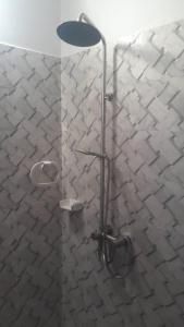 a shower with a glass door in a bathroom at CHEZ NDAYE AMY in Dakar
