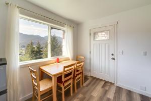 a dining room with a table and chairs and a window at Sleek Juneau Studio with Spectacular Views and Scenery in Juneau