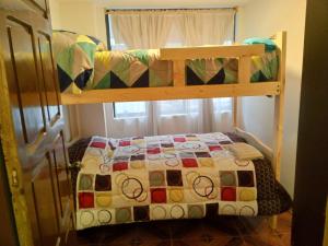 sypialnia z łóżkiem piętrowym i kołdrą w obiekcie La casa de Almicar Departamento 3 w mieście Juivi