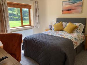 a bedroom with a bed and a window at Lissyclearig Lodge in Kenmare