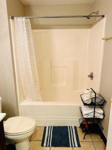 a bathroom with a white tub and a toilet at Rustic ridge 01 in Gatlinburg