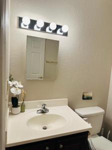 a bathroom with a sink and a mirror and a toilet at Rustic ridge 01 in Gatlinburg