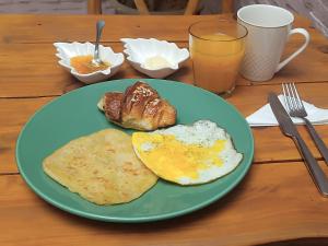 a green plate with eggs and toast on a table at Dar Suncial in Marrakesh +42 photos
