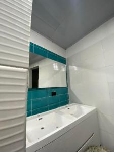 a bathroom with a white tub and a mirror at Hotel Hostal Caps Cartagena in Cartagena de Indias