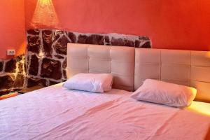 a bedroom with a white bed with two pillows at Deniz ve Doğa iç içe Tatil in Ayvalık