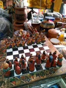 um tabuleiro de xadrez com estatuetas numa mesa em Jhonyximena em Copacabana