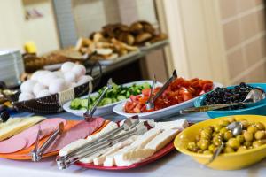 a table with plates of food on a table at Yellow Rose Pansiyon in Çanakkale