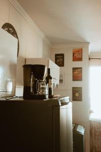 a kitchen with a coffee maker on top of a refrigerator at Cantinho da Ernesto in Santa Maria +18 photos