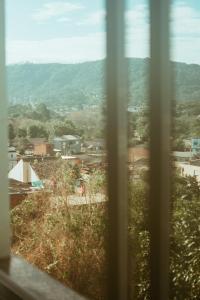 a view of a city from a window at Cantinho da Ernesto in Santa Maria