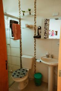 a bathroom with a toilet and a sink at Cantinho da Ernesto in Santa Maria