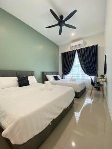 a bedroom with two beds and a ceiling fan at LYL HOMESTAY-IPOH 10Pax 4R in Ipoh