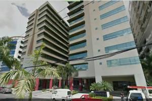 a tall building with cars parked in front of it at Suite 211 in Quito