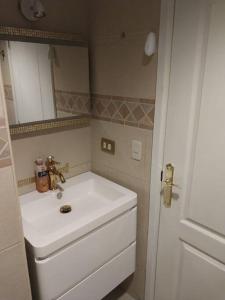 a bathroom with a white sink and a mirror at Suite 211 in Quito