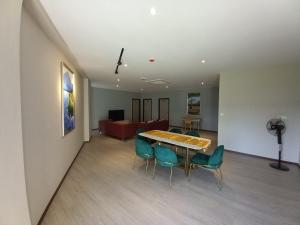 a living room with a table and chairs and a couch at KAN JIA in Miri