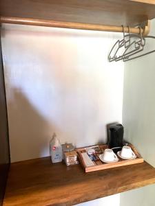a wooden shelf with a coffee maker and cups on it at Matam-is Cafe & Homestay in General Luna +22 photos