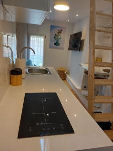 a kitchen counter with a tablet on a counter top at L'EDEN in Étampes