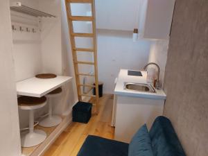 a small kitchen with a ladder next to a sink at L'EDEN in Étampes +39 photos