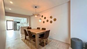 a dining room with a wooden table and chairs at Clara's Home in Matosinhos
