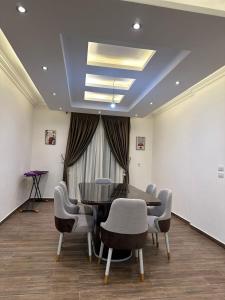 a dining room with a table and chairs at Two million hotel 3 in 6th Of October