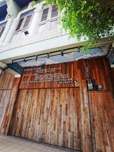 a wooden garage door with a sign on it at 7 Wooden Lodge Ipoh City in Ipoh