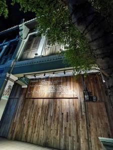 a large wooden gate in front of a building at 7 Wooden Lodge Ipoh City in Ipoh