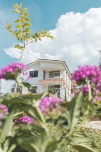 佩雷拉的住宿－Florida Koi，前面有粉红色花的白色建筑