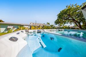 a swimming pool with blue water in front of a house at Sea Salt Harbor in Marathon