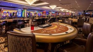 a casino with tables and chairs and poker machines at Attractive Unit by Paris Casino Heart of Strip Las Vegas in Las Vegas