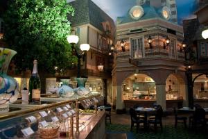 a restaurant with tables and vases in a building at Attractive Unit by Paris Casino Heart of Strip Las Vegas in Las Vegas