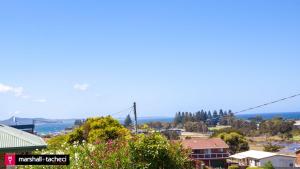 a view of a city with a bridge in the background at Bermagui Breeze Holiday House 5 bedroom 18-20 Mumbulla Street - Bermagui in Bermagui