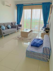 a living room with a couch and a table at Atlantis Residence Melaka ForMuslims Homestay in Melaka